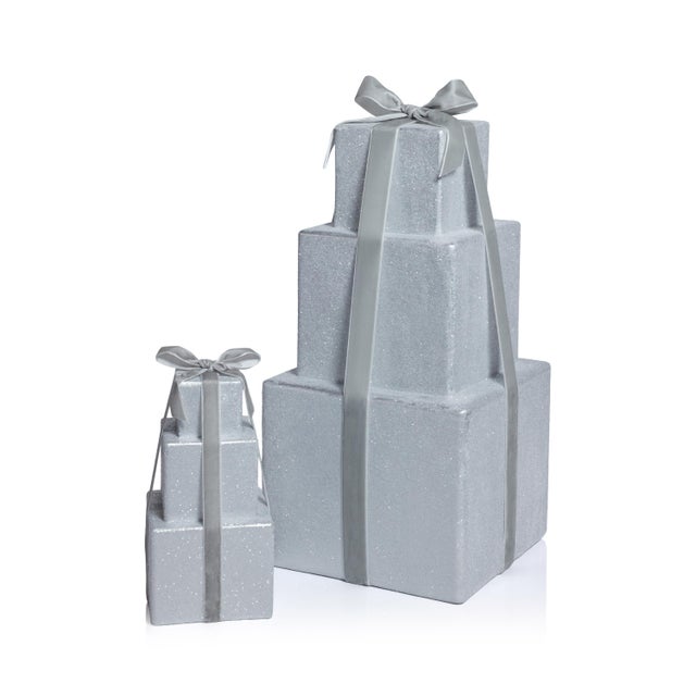 Add a festive accent to your holiday setup with this stacked present figurine. Featuring three gift boxes in a tiered...