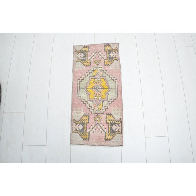 This is a vintage Turkish nomadic wool rug. The piece was handmade in the 1960s.