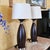 Pair of Contemporary Espresso Wood Hourglass Lamps With Brushed Nickel Accents and Linen Shades For Sale - Image 13 of 18