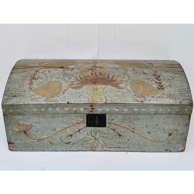 Dating to circa 1820, this charming American folk art pine storage chest retains its beautifully weathered original powder...