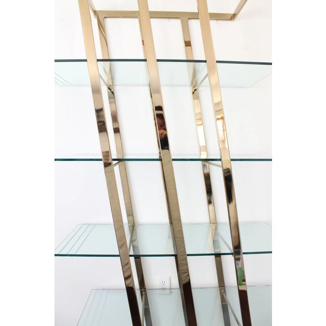 Amazing vintage brass etagere shelf unit in a unique angular shape. Super shiny brass frame stands diagonally and holds...