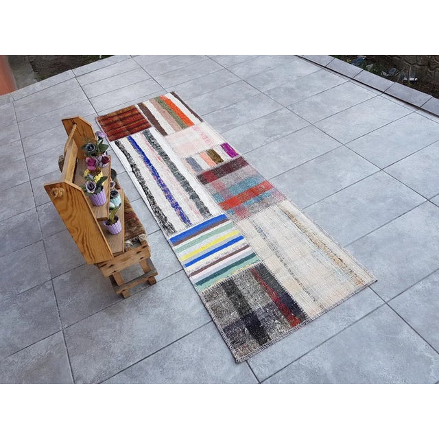 This is a vintage Turkish Oushak rug from the Mid 20th Century. The piece was hand-knotted.