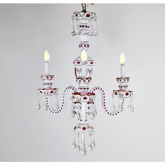 This stunning bohemian Czechoslovakian faux-porcelain glass chandelier was created in the style of Moser Glass Company. It...
