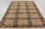 This 7x10 contemporary Scandinavian rug, hand-knotted in wool, features a bold geometric lattice with gold medallions,...