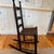 This is a mid 19th century Shaker style ricking chair with rush seat and original ebony paint tone with nicely aged...