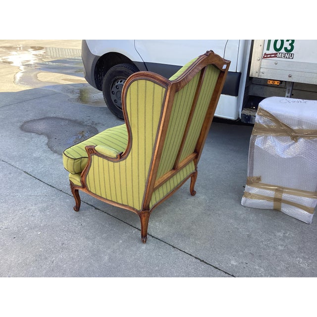 Stunning French Bergere arm chair upholstered in a chic lime green wool fabric. These chairs feature a beautifully carved...