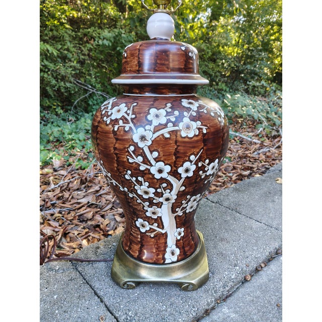 Striking pair of vintage ceramic table lamps in classic ginger-jar form, decorated with hand-painted-style white flowering...