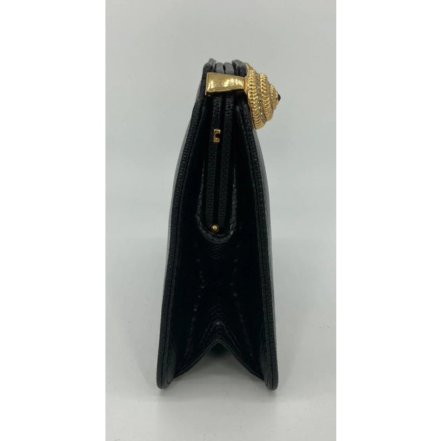 Judith Leiber Black Lizard Crystal Shells Clutch in very good condition. Black lizard exterior trimmed with gold shells...