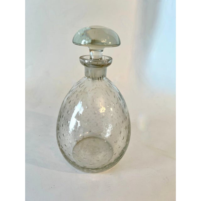 A small Decanter with stopper. The piece is a nice addition to the bar for those small amounts of liquor or aperitif....