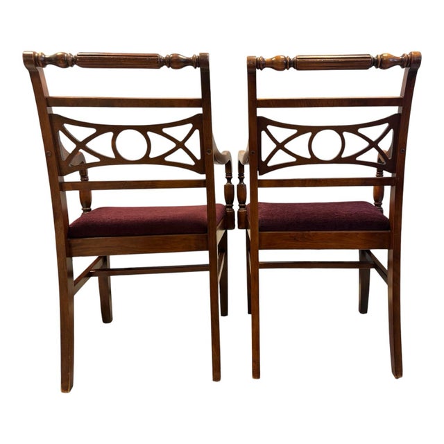 A handsome pair of vintage American Colonial Revival captain’s armchairs crafted from solid hardwood and dating to...