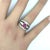 A stylish platinum band ring featuring a fine 1.46 carat ruby. The ruby has a lovely oval-shape along with a vibrant and...
