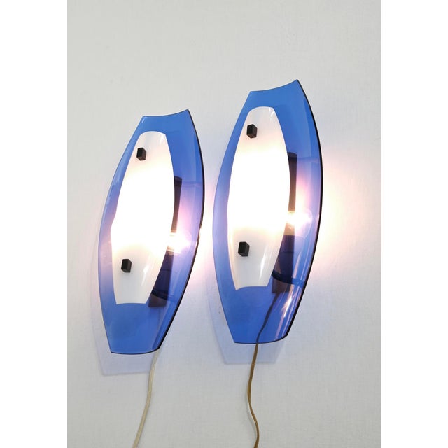 A pair of vintage Italian wall lamps (sconces) from the 1970s, crafted from acrylic glass and Perspex. These are iconic...