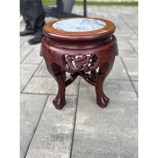 Stunning rosewood plant stand with inset marble top. Features beautiful pierced dragon carvings on the apron and elegant...