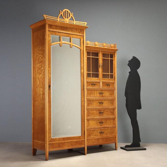 Liberty wardrobe in ash and maple, attributed to the renowned designer Ernesto Basile and produced by the Grandi Magazzini...