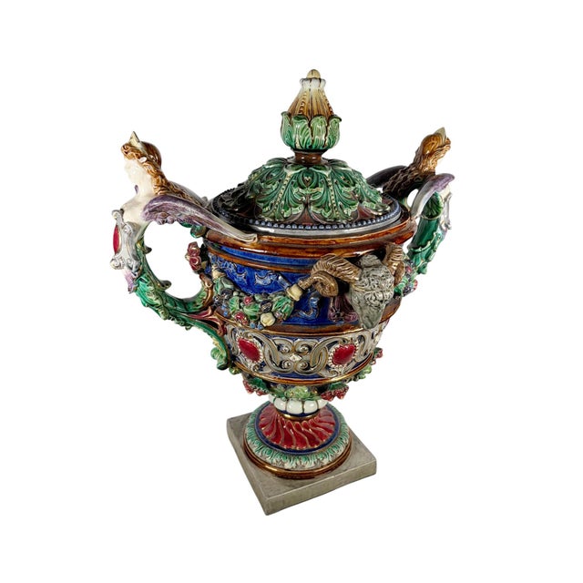 A monumental and highly decorative majolica urn with lid, richly modeled with winged female caryatid handles and opposing...