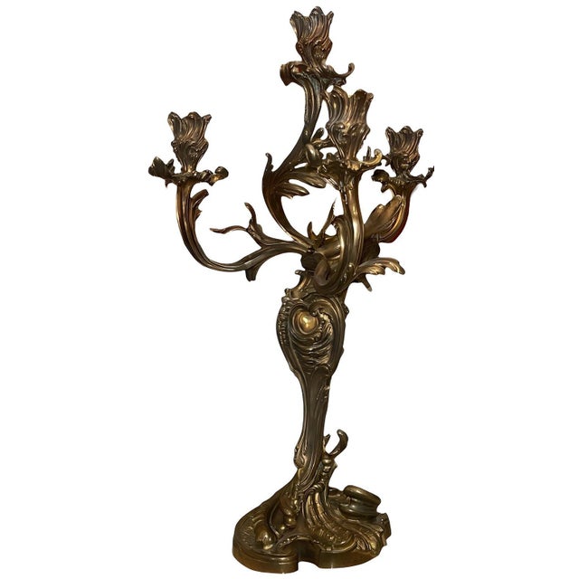 A striking pair of Baroque-style gilt bronze candelabras, executed in the richly sculptural manner associated with the...