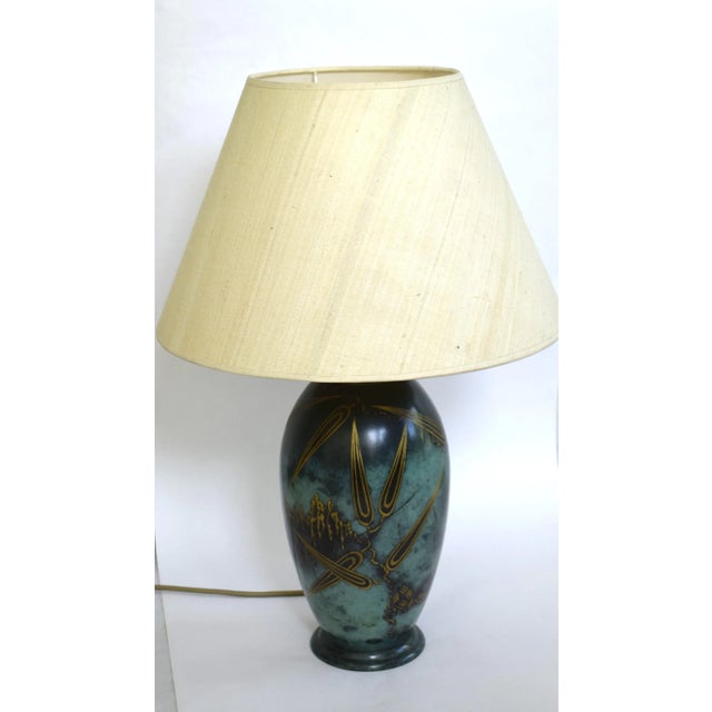 Elongated baluster shape on a ring stand, so-called "Ikora" metal, green fire-patinated brass, engraved, with fine silver...