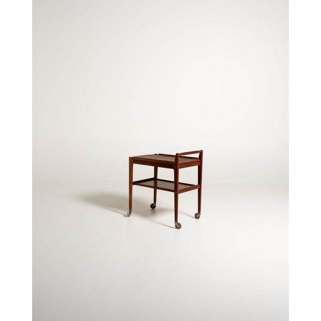 Teak serving trolley from the 1950s/1960s, by Erik Gustafssons Möbelfabrik, with a removable tray with curved edges and a...