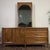 Vintage Kroehler Custom Crafter dresser or credenza with a matching arched mirror, finished in warm walnut veneer with a...