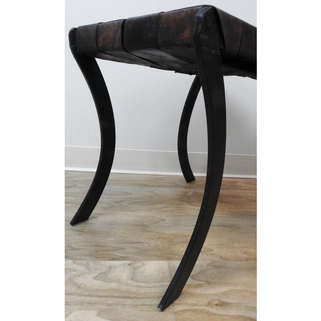 Strips of leather are woven to from the seat on this Classic stool which sits atop Saber legs. The curves of the legs lend...