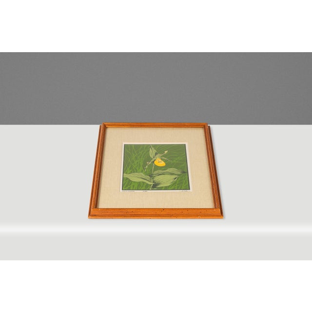 Introducing an elegant framed and signed limited edition lithograph of a lady slipper orchid by the accomplished American...