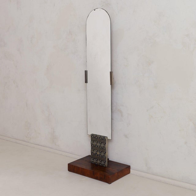 This 1970s Italian floor mirror is distinguished by its monolithic form and assertive geometry. The elongated, arched...