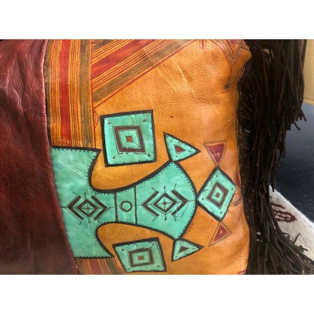 Unique tent cushion made from vintage sealed Tuareg leather, composed of three panels of reddish and ochre leather...