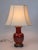 Vintage Asian Style Frederick Cooper dark red ceramic, wood and brass table lamp with floral motif. Shade is not included....