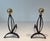 This pair of decorative andirons is made of wrought iron and brass. This is a French work. Circa 1970