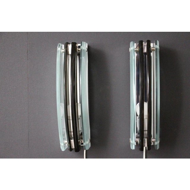 This pair of modernist Italian art glass sconces features 2 smoked and 2 frosted glass curved panels mounted on a chromed...