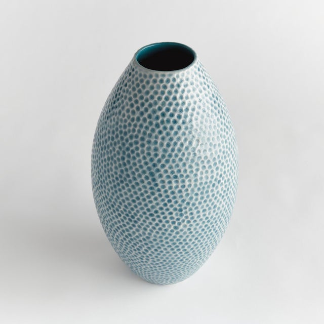 With a streamlined shape, reactive glaze and highly textured organic dot pattern, this decorative vase is a true work of...