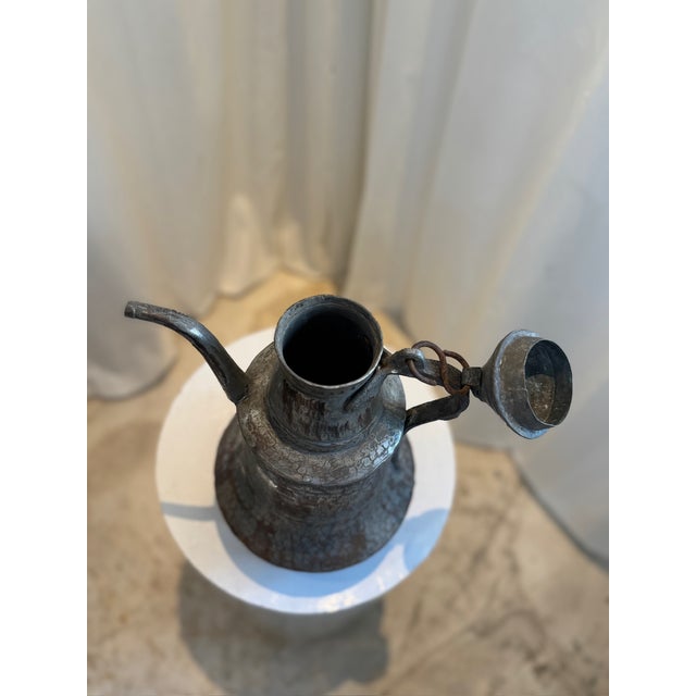 This exquisite antique Dallah coffee pot is a stunning example of Middle Eastern craftsmanship. Hand-hammered from mixed...