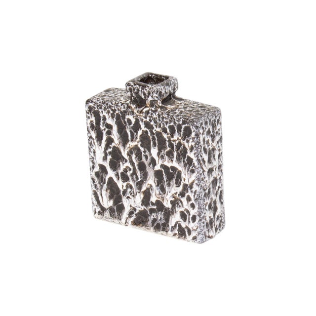 A West German ceramic fat lava vase produced by Jopeko Keramik. This vase features a black and white fat lava glaze and a...