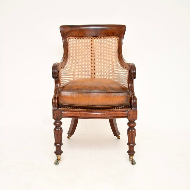 A beautiful and very well made antique William IV period leather caned armchair. This was made in England, it dates from...