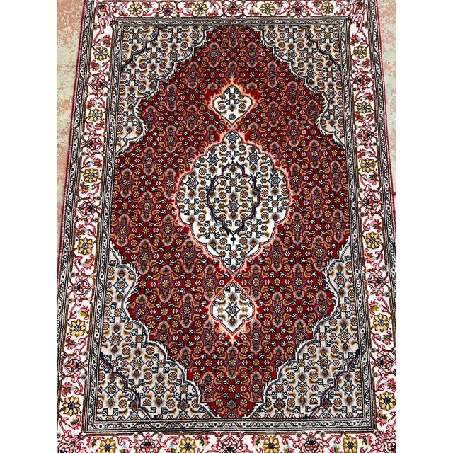 Fine Persian Tabriz Mahi Fish rug, hand-knotted in Iran from 100% wool with silk highlights. Measuring 2’7” x 3’11”, the...