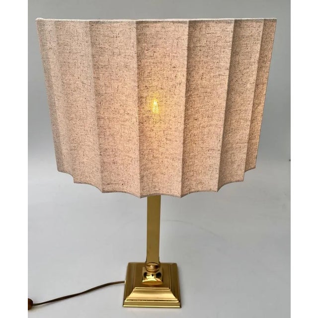 High, solid, but elegant vintage brass table lamp from Belgian 'DeKnudt' with a new sand-colored shade. This piece is...