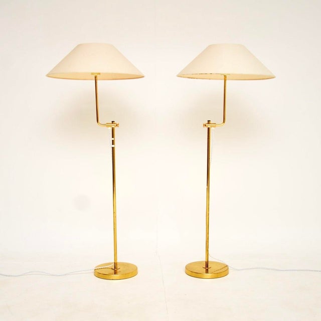 A stunning pair of vintage Swedish brass rise and fall lamps by Bergboms. They were recently imported from Sweden, they...