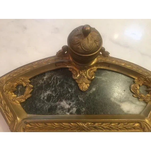 This is an antique French bronze and marble inkwell. The piece is from the early 20th century. 11 1/2 " W 6" D 3" Tall