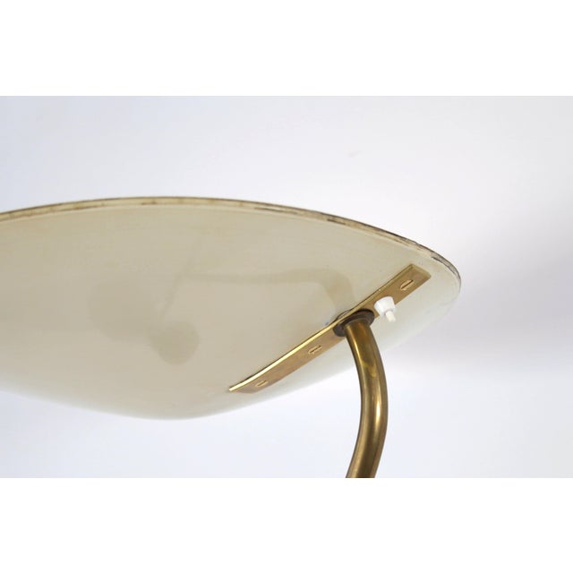 Floor lamp made by Eberth Zurich, Switzerland, 1950. The brass lamp has painted metal screens and performs two functions....