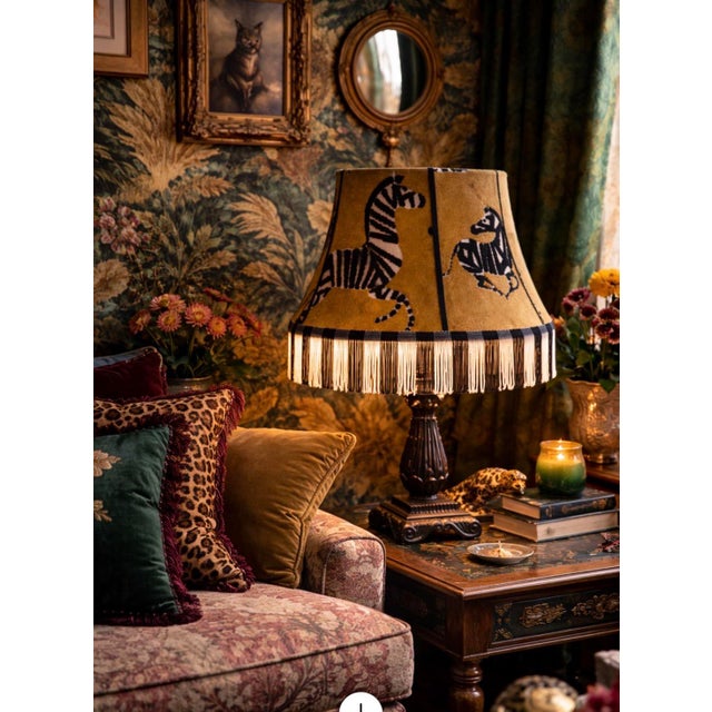 A bold and characterful vintage silk lampshade featuring playful zebra motifs set against a rich golden/tan ground,...