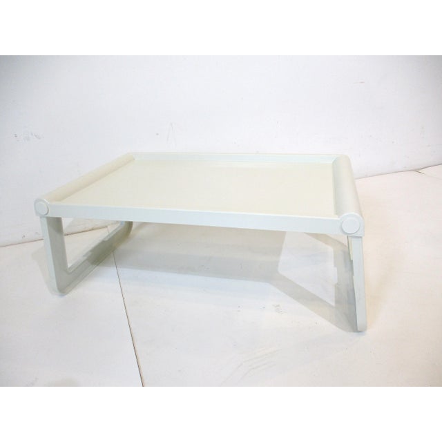 A Mid Century ABS white plastic folding bed table or serving tray with snap out legs and inset handles to each end . This...