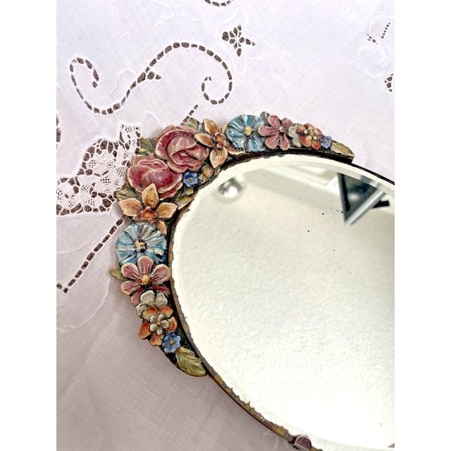 Vintage Barbola Mirror. An oval frame of wood. A diverse array of colors, Reds, pinks,yellow and blues adorn the mirror's...