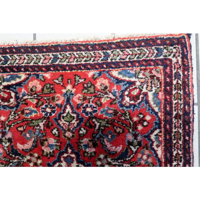 Elevate your living space with the timeless elegance of our Handmade Vintage Persian Sarouk Rug from the 1960s. Measuring...