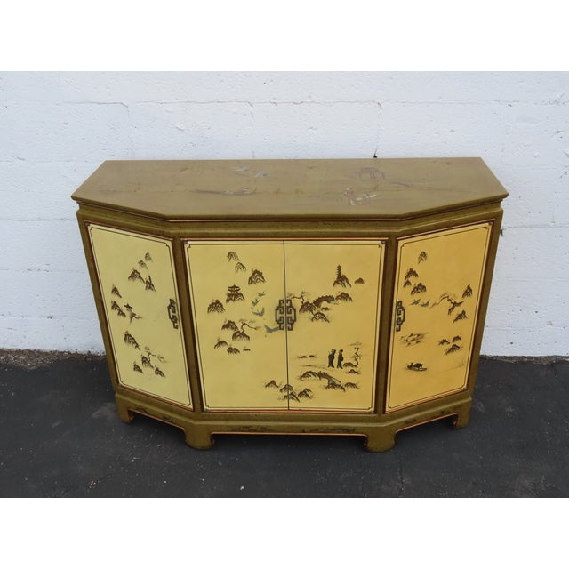 This wonderful Buffet Storage Cabinet is made out of wood. The Server has a Hollywood Regency Asian style Chinoiserie...