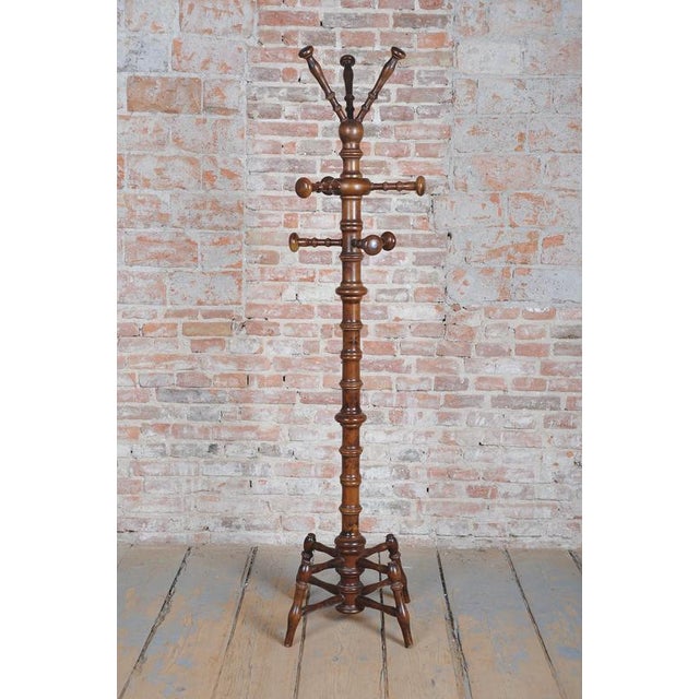 This freestanding coat rack is a monumental and highly elegant example of craftsmanship from the late 19th century, made...
