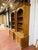A handsome pair of tall antique pine bookcases featuring classic architectural styling with arched openings, fluted...