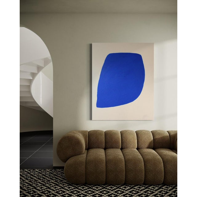 This minimalist abstract canvas presents an organic form in a deep blue, inspired by the purity of cobalt blue pigment....