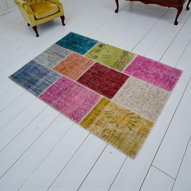 This contemporary Anatolian patchwork rug is a curated collage of history, meticulously assembled from hand-knotted...