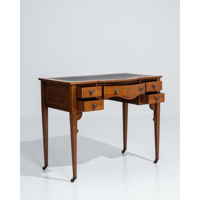 A classic Edwardian desk featuring a leather writing surface, combining refined craftsmanship with everyday usability. The...