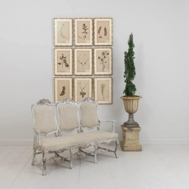 A richly carved, 19th century Swedish sofa bench in the Rococo style. A rare piece found in northern Sweden. This...